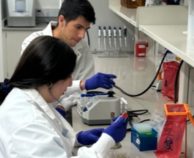 2 students in microbiology lab testing samples